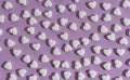 Top view of Seamless pattern of white heart shape pills on purple background Royalty Free Stock Photo