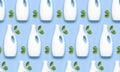 Seamless Pattern of White plastic packaging of laundry detergent, liquid powder, washing conditioner, green leaves on blue