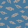 Seamless pattern with white ropes and marine knots over green background