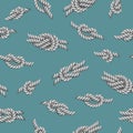 Seamless pattern with white ropes and marine knots over green background