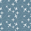 Seamless pattern with white silhouettes of passenger airplanes and flight paths