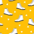 Seamless pattern with white womens shoes on yellow background. Sneakers in flat style. Leather boots side view. Flat design