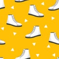 Seamless pattern with white womens shoes on yellow background. Sneakers in flat style. Leather boots side view. Flat Royalty Free Stock Photo
