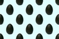 Seamless pattern of a whole chocolate Easter egg on a blue background, tinted. Easter sweet chocolate background Royalty Free Stock Photo