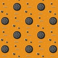 Seamless pattern with whole pepperoni pizza tomatoes on orange background