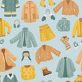 The seamless pattern with winter clothes. Coats, The vector set of winter clothes. Coats, hats, gloves, shoes and socks Royalty Free Stock Photo