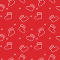 Seamless pattern of winter warm Santa boots on a red background