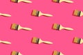 Seamless pattern from wooden paint brushes on fuchsia pink background. Home interior decoration design