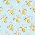 Seamless pattern of yellow bananas on a blue background Royalty Free Stock Photo