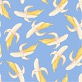 Seamless pattern yellow bananas on a blue background. Royalty Free Stock Photo