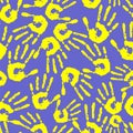 seamless pattern of yellow handprints on a blue background, texture Royalty Free Stock Photo
