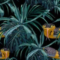 Seamless pattern with yellow snakes and blue tropical plants. Royalty Free Stock Photo