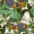 Seamless pattern with yellow snakes and bright tropical plants: ficus, palm and bananas leaves. Royalty Free Stock Photo