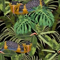 Seamless pattern with yellow snakes and bright tropical plants: ficus, palm and bananas leaves. Royalty Free Stock Photo