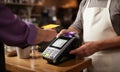 Seamless payment Man\'s close-up, utilizing contactless method, at the cafeteria checkout.