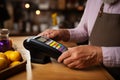 Seamless payment Man\'s close-up, utilizing contactless method, at the cafeteria checkout.