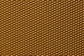 Seamless plastic texture background. Close-up of a detail from a gold glittering surface of a cosmetic bag. Beautiful backdrop.