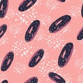 Seamless random pattern with doodle stylized donuts elements. Navy blue and purple colored food ornament on pink background with Royalty Free Stock Photo