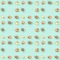 Seamless regular creative pattern with bright shiny little Christmas balls on mint colored paper Royalty Free Stock Photo