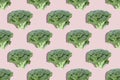 Seamless regular creative pattern of broccoli slices on a pink background.