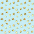 Seamless regular creative pattern with gloden shiny small Christmas balls on blue paper