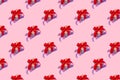 Seamless regular pattern with boxes of gifts on a pink background. Hard light. New Years, Christmas and birthday concept