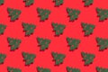 Seamless regular pattern with green Christmas trees on a red background. Hard light. The concept of New Years and Christmas Royalty Free Stock Photo