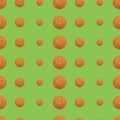 Seamless repeating pattern of oatmeal cookies on a green background