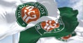 Seamless slow motion of three flags with the Roland-Garros logo waving in the wind