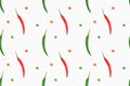 Seamless spice pattern with red and green chili pepper pods vertically, slices of cut red pepper on white background