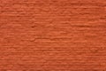 seamless texture and full frame background of brick wall covered with matte orange plaster Royalty Free Stock Photo