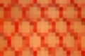 Seamless texture of a red plastic mesh with abstract repeating patterns in the form of rombs on brown background