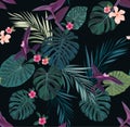 Seamless tropical vector pattern with green palm leaves and hibiscus flowers on dark background. Royalty Free Stock Photo