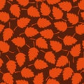 Seamless vector autumn pattern with orange leaves on a brown background Royalty Free Stock Photo