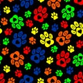 Seamless vector pattern: colorful paw prints, decorated with hearts and the word love, on a black background Royalty Free Stock Photo