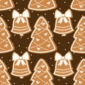 Seamless vector pattern with gingerbread cookies shaped like Christmas trees and bells decorated with white icing on a dark Royalty Free Stock Photo