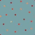 Seamless vector pattern with ladybug colored polka dots on a blueish background