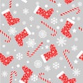 Seamless vector pattern with red and white christmas stocking socks, candy canes and snowflakes