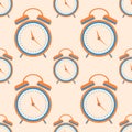 Seamless vector pattern. Symmetrical background with orange closeup alarm clocks on the light background