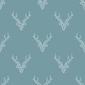 Seamless winter mosaic pattern with white deer head with antlers on blue background. simple faceted