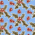 Seamless winter pattern with hand drawn holly leaf and berry elements on a blue background for festive decoration. The image Royalty Free Stock Photo