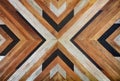 Seamless yellow, black, white and dark brown color lumber in arrows or chevron pattern to the center for texture background