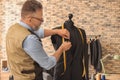 Seamster tailoring jacket on mannequin in atelier Royalty Free Stock Photo