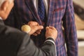 Seamster tailoring suit for male client in atelier Royalty Free Stock Photo