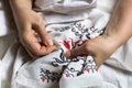 Seamstres`s hands. Female hands with a needle, thread and thimble. Woman embroiders clothes