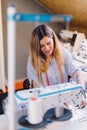 Seamstress dressmaker woman working with sewing machine in workshop Royalty Free Stock Photo