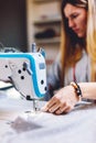 Seamstress dressmaker woman working with sewing machine in workshop Royalty Free Stock Photo