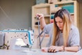 Seamstress dressmaker woman working with sewing machine in workshop Royalty Free Stock Photo