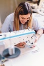 Seamstress dressmaker woman working with sewing machine in workshop Royalty Free Stock Photo