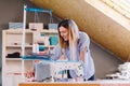 Seamstress dressmaker woman working with sewing machine in workshop Royalty Free Stock Photo